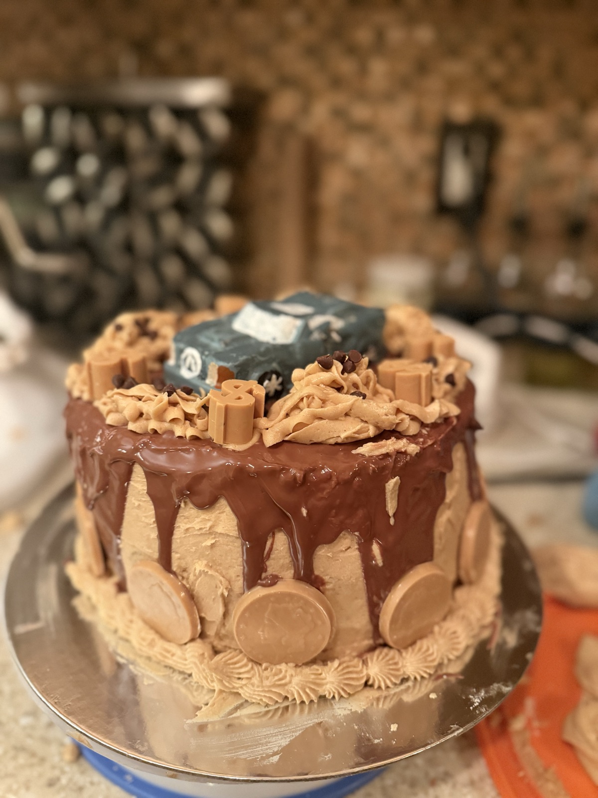 Chocolate drip cake with a candy race car