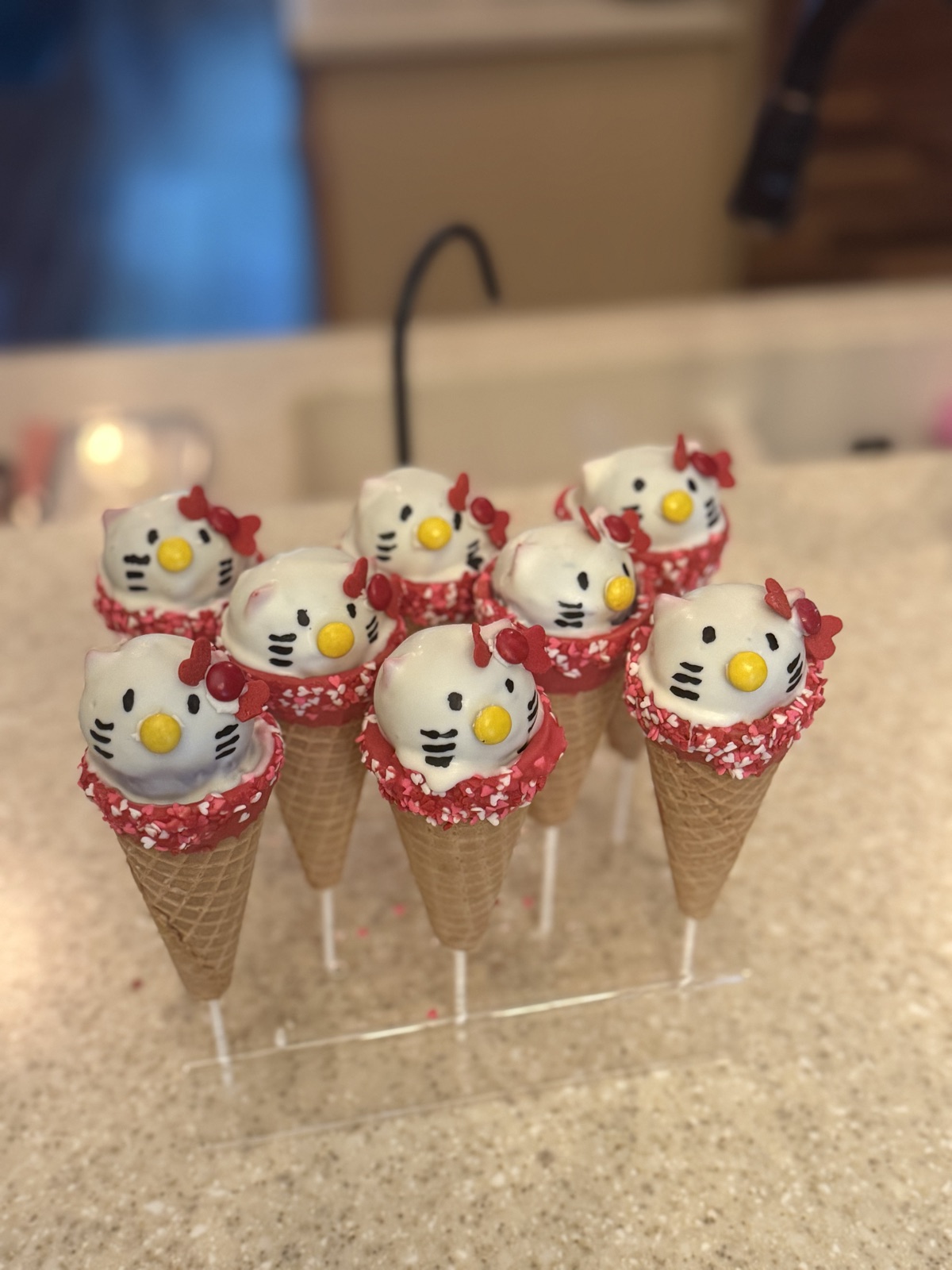 Pink Hello Kitty cake pops served in mini ice cream cones