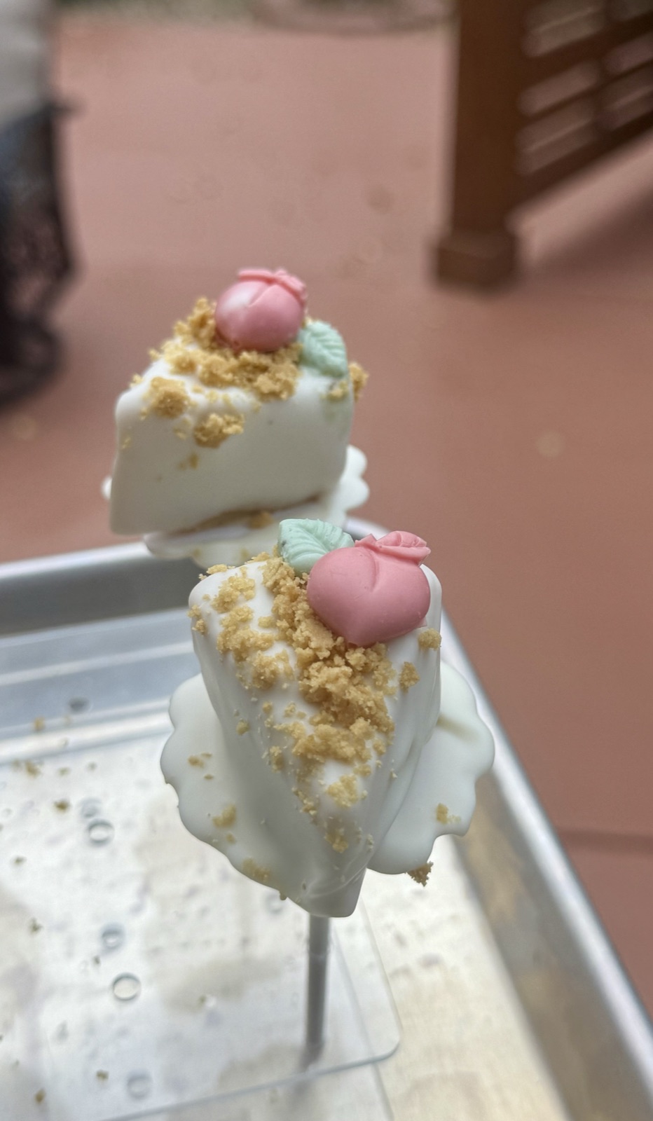 White-chocolate cheesecake cake pops topped with sugar roses